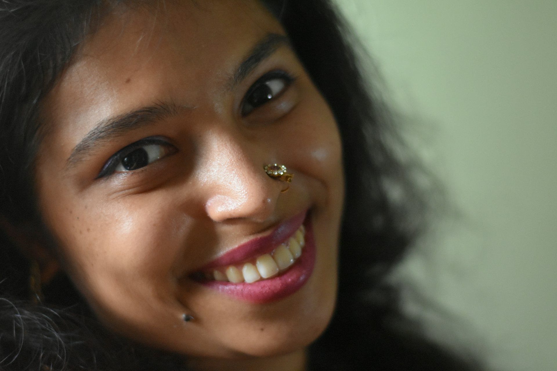 A close up of a woman with a nose ring